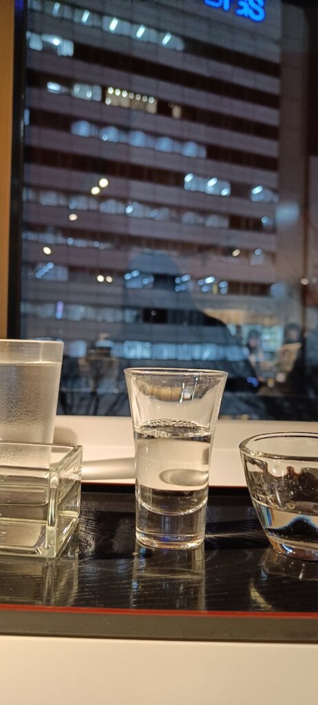 Three small sake glasses in a sake bar in Tokyo