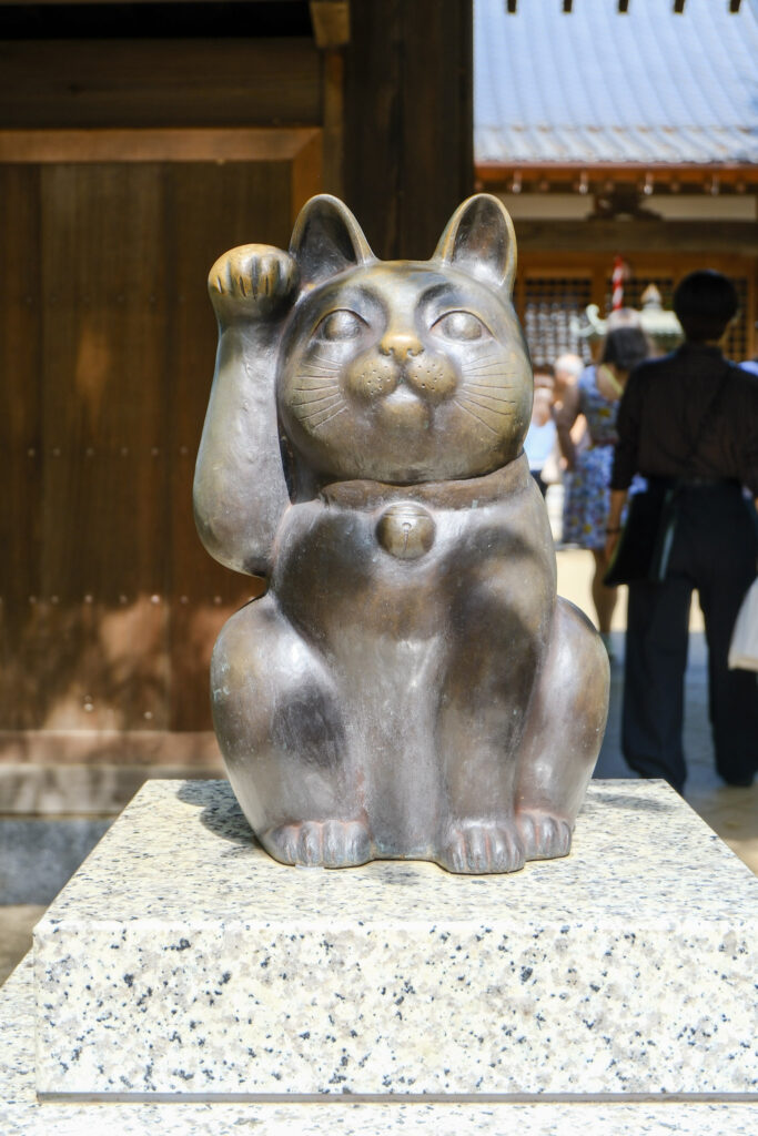 A bronze maneki neko in Gotokuji, tokyo