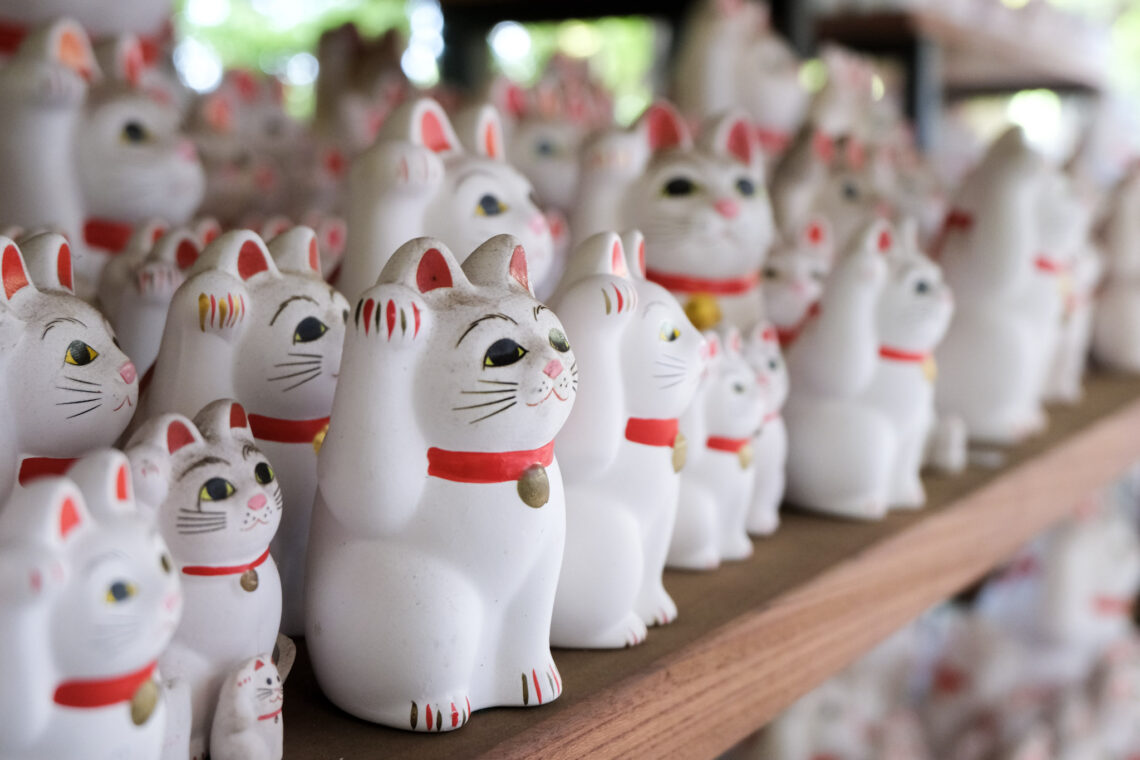 Thousands of beckoning maneki neko at Gotokuji Temple