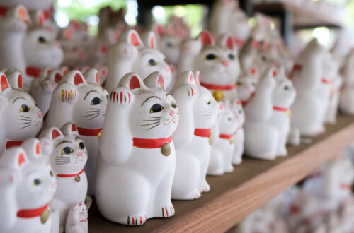 Thousands of beckoning maneki neko at Gotokuji Temple