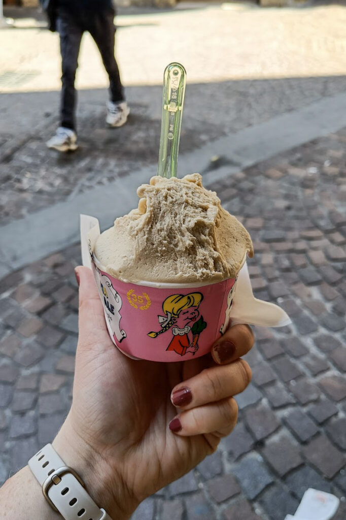 Hand holding ice cream gelato cup