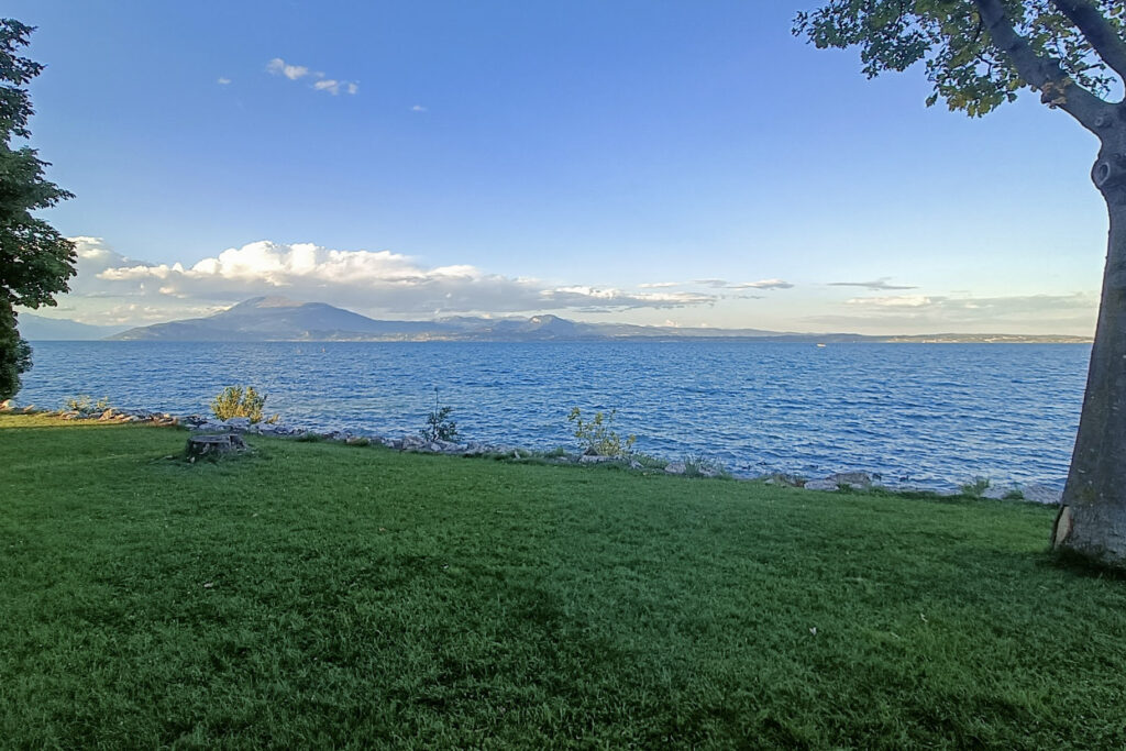 A view of Lake Garda, Italy, with a mountain in the distance
