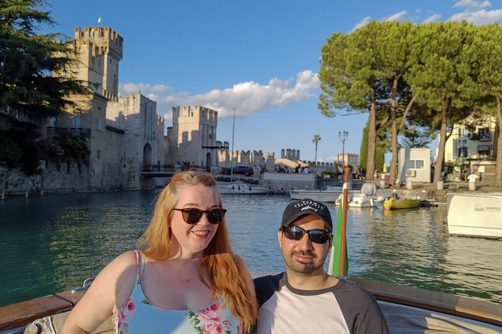 People on boat near Scaliger castle in Sirmione, Lake Garda