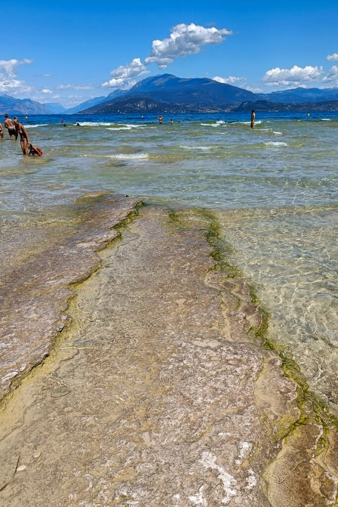 Clear water with rocky shoreline in Jamaica Beach Sirmione