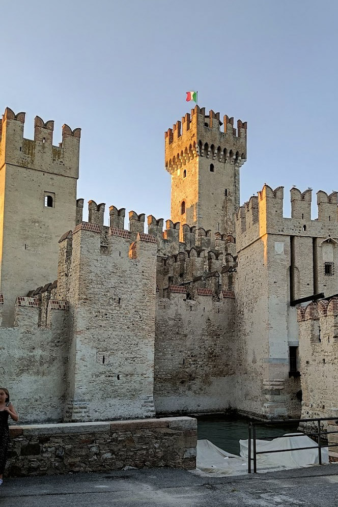 Historic Scaliger castle in Sirmione with Italian flag