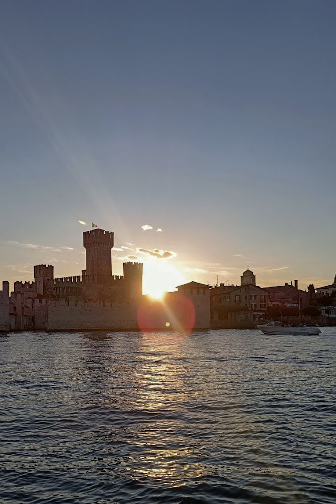Castle silhouette against sunset sky, Sirmione, Lake Garda