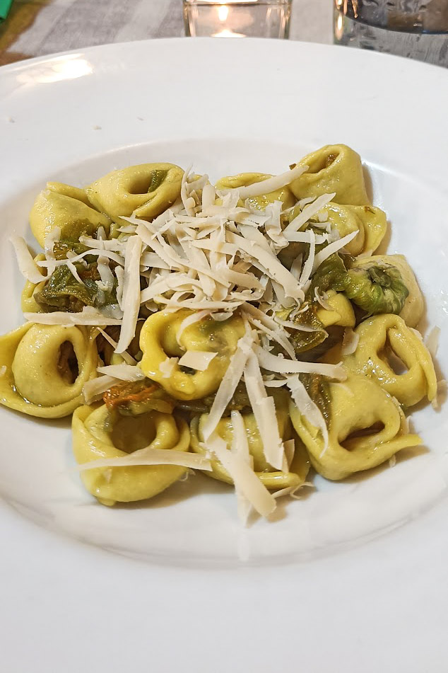 Vegan tortellini in La Lanterna restaurant in Verona, topped with grated vegan cheese