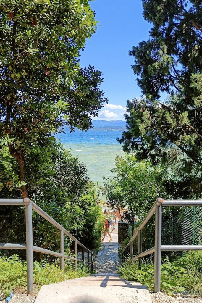 Pathway leading to a serene beach in Sirmione, Lake Garda