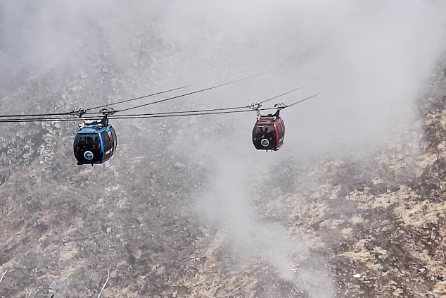 Two gondolas above foggy landscape in Hakone, above the sulphur springs