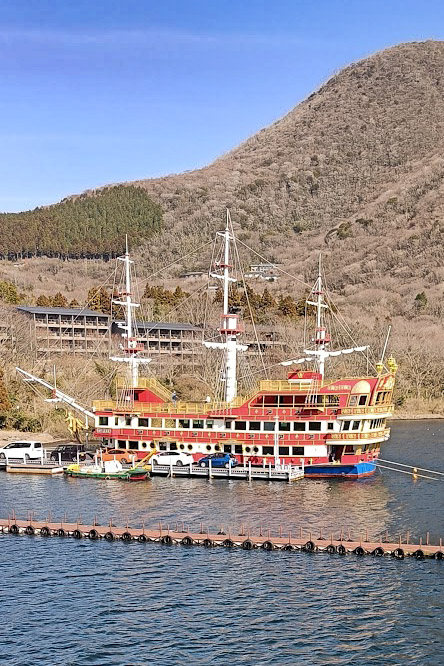 Colourful pirate ship docked by mountains in Hakone