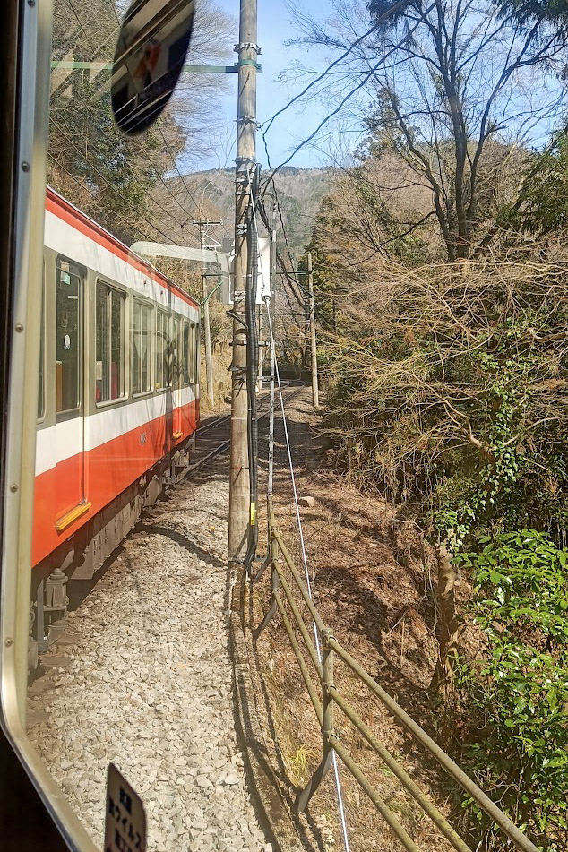A view of the Hakone Tozan Railway winding around a bend in Japan