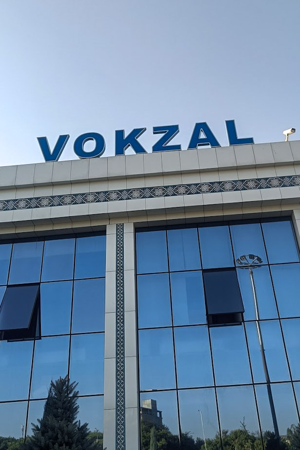 A train station in Tashkent, Uzbekistan with a sign reading Vokzal