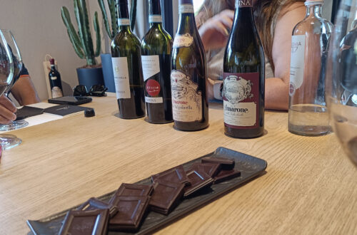 Wine tasting at Farina winery in Valpolicella, with chocolate to accompany the wine bottles - one to factor into your Valpolicella budget