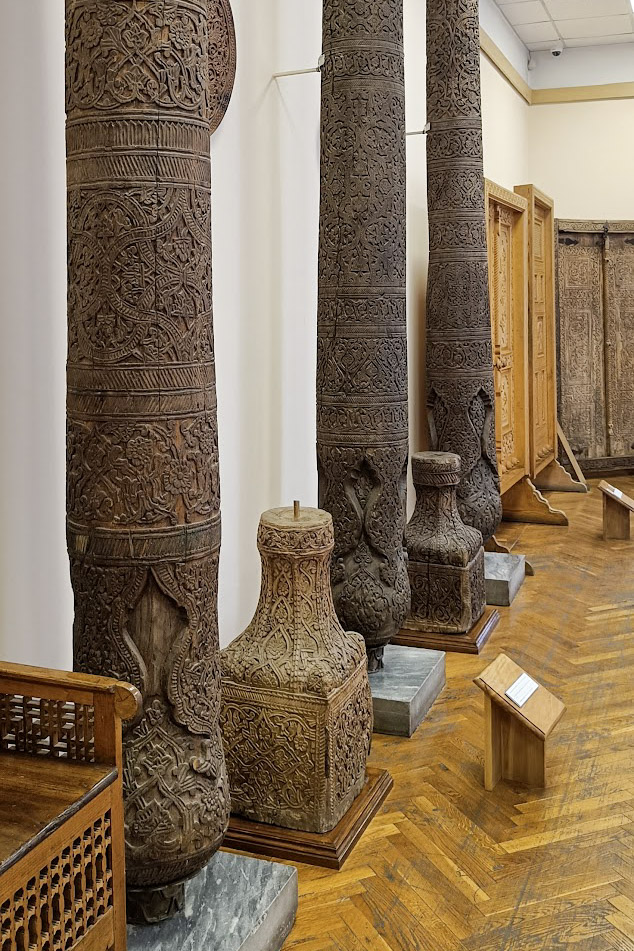 Intricately carved sandalwood pillars inside the Museum of Applied Arts in Tashkent, Uzbekistan
