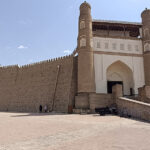 The imposing mud walled entrance to the the Ark of Bukhara, with a ramp up to the gate - something you'll need to see on a two days in Bukhara itinerary