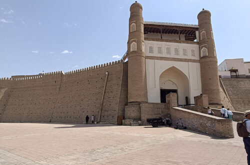 The imposing mud walled entrance to the the Ark of Bukhara, with a ramp up to the gate - something you'll need to see on a two days in Bukhara itinerary