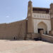 The imposing mud walled entrance to the the Ark of Bukhara, with a ramp up to the gate - something you'll need to see on a two days in Bukhara itinerary