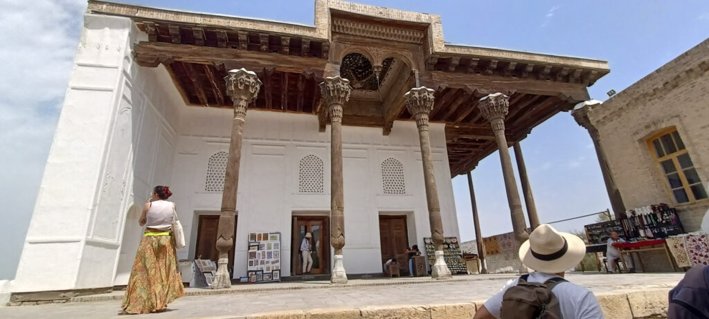 The front iwan (or porch) of the Juma Mosque inside the Ark of Uzbekistan, supported by tall slender wooden columns