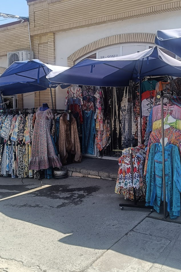 Clothes for sale in a shop in Siyob Bazaar, Uzbekistan
