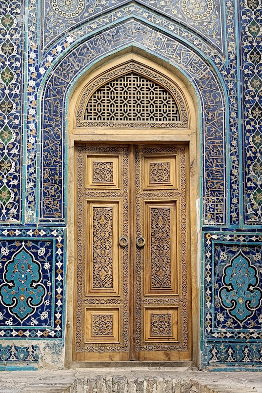 A door in Shah i Zinda necropolis in Samarkand Uzbekistan, surrounded by blue tiles