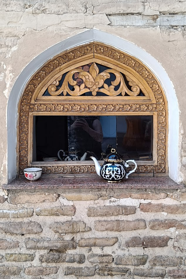 A small window with a little teapot and a teacup in Uzbekistan