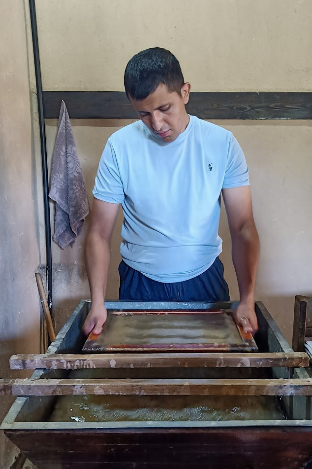 A man at work making paper in Meros Paper Mill