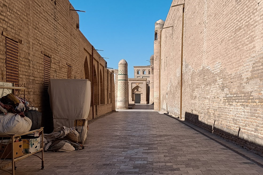 A street in Khiva with shops and a minaret, one of the many things to do in Khiva