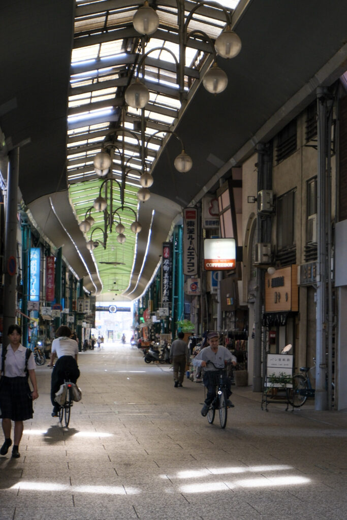 Cyclists along the Onomichi shopping street