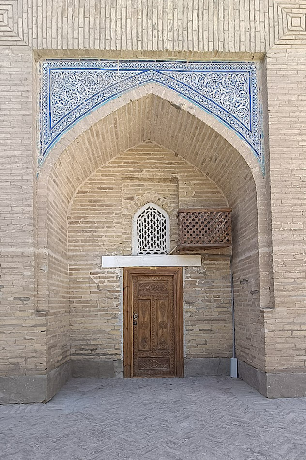 A doorway in the Muhammad Amin Khan Madrasah, entrance to a hotel room