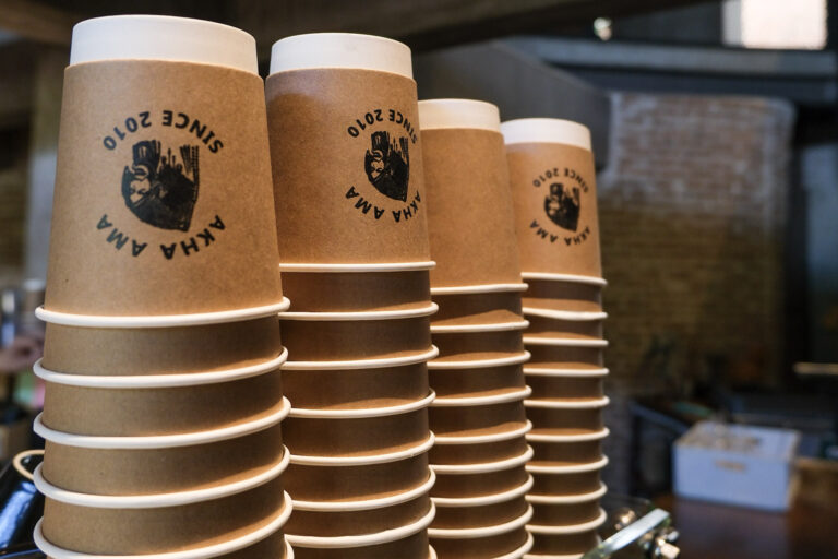 Coffee cups printed with the Akha Ama Coffee logo in chiang mai