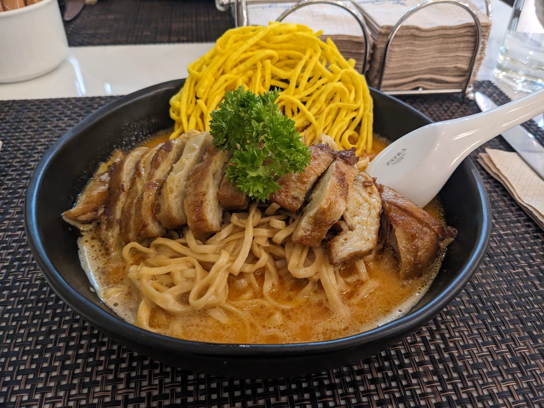 Bowl of noodles with vegan chicken and herbs, Khao soi from the restaurant at Away Chiang Mai