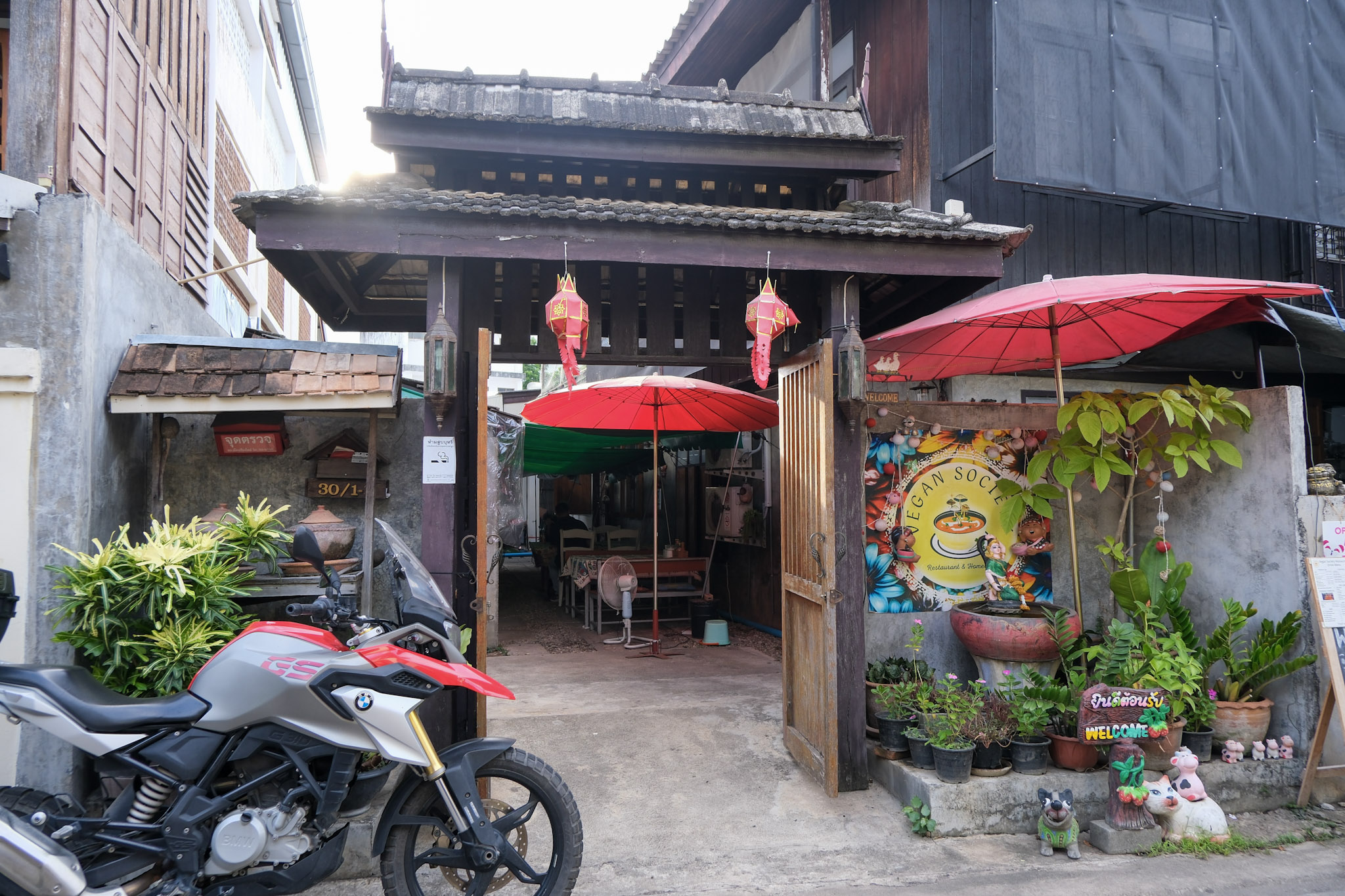 Quaint entrance with umbrellas and plants