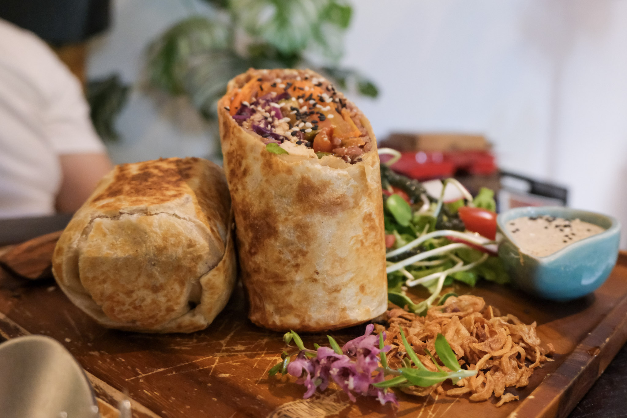 Two burritos with fresh ingredients