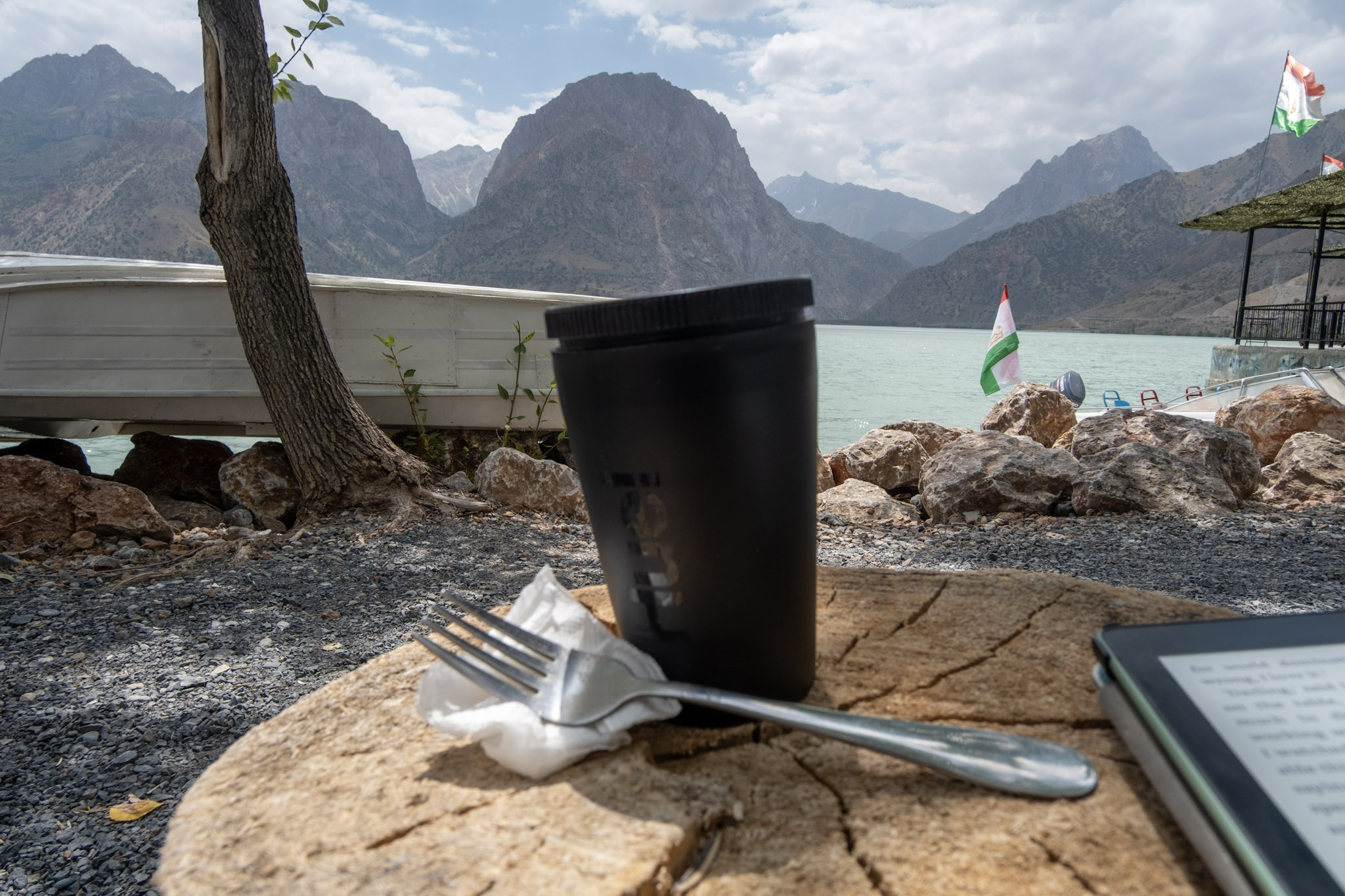Coffee cup by scenic mountainside